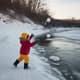Child Playing Frozen River Bank - Cinematic Nature Stock Video for Wildlife and Weather Projects 1