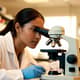 Female Researcher Looking into Microscope - Cinematic Educational Stock Video for Science and Medical Projects 4