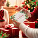 Hand Placing Christmas Card - Festive Holiday Stock Video for Seasonal Campaigns and Celebrations 1