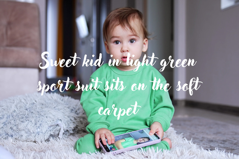Kid in Green Tracksuit on Sofa - Cinematic Lifestyle Stock Video for Family and Children Content Creators